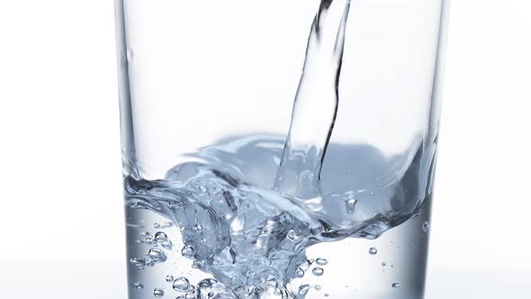 980003 Water being poured into Glass against White Background, Slow Motion alt