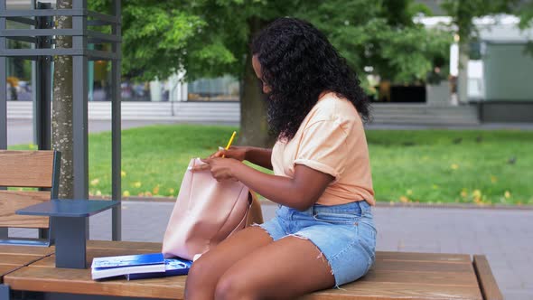 African Student Girl with Bag and Books in City alt