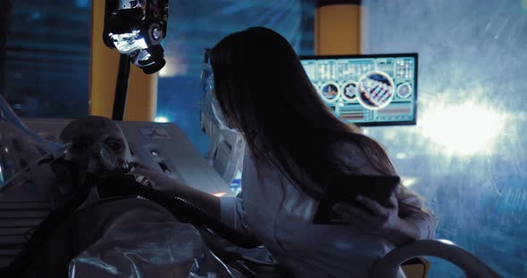 Beautiful Female Scientist Fixes Surveillance Devices on an Alien