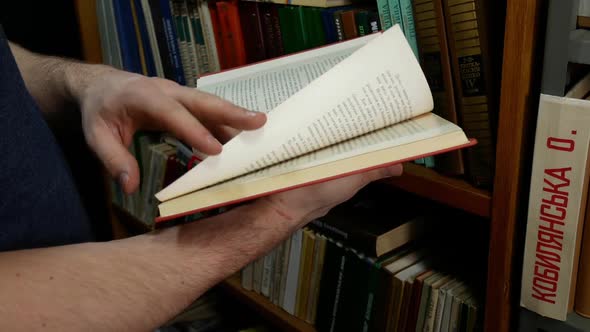 Man Leafing Through A History Book