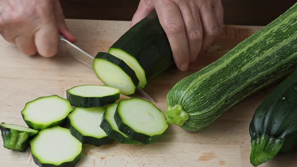 Slicing zucchini. Fresh zucchini on cutting board