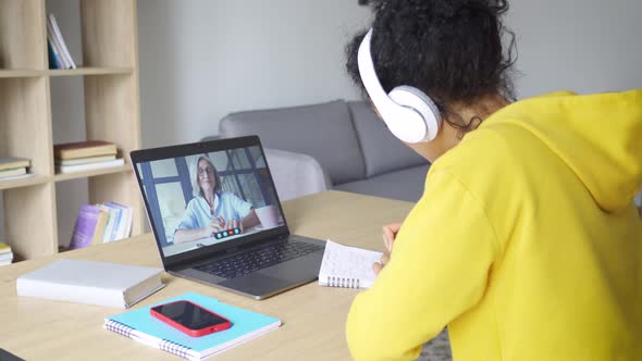 African American Female Student Having Video Educational Class on Laptop alt