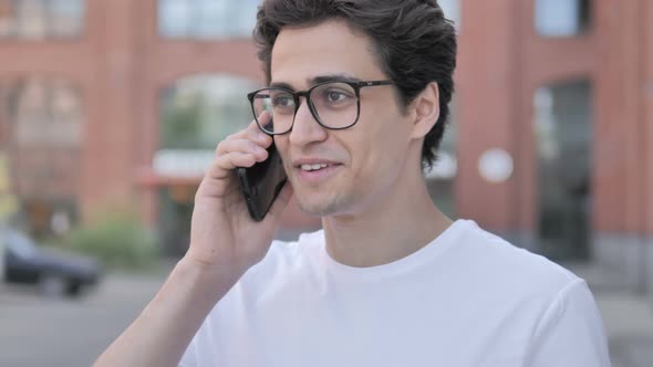 Young Man Talking on Phone alt