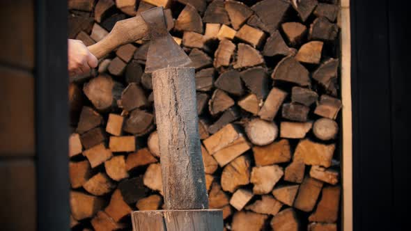 Chopping Wood with an Ax in Woodpile alt