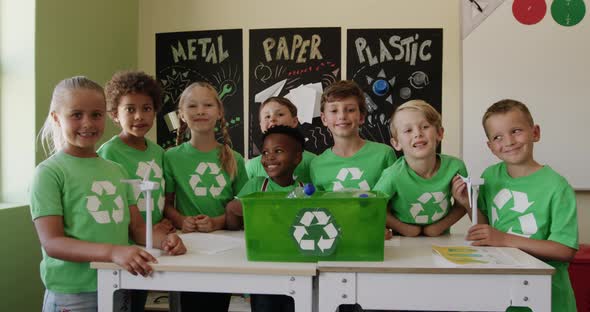 Group of kids wearing recycle symbol t shirt in the class alt