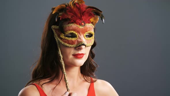 Portrait of beautiful woman wearing masquerade mask 4k alt