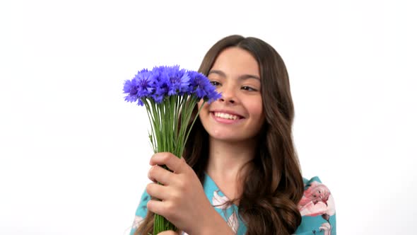 Flower Bouquet in Hands of Cheerful Child Long Hair Smelling Wildflower Centaurea Flowers