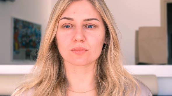 Confident Young Beautiful Blueeyed Blonde Woman Without Makeup Looks Into the Camera alt