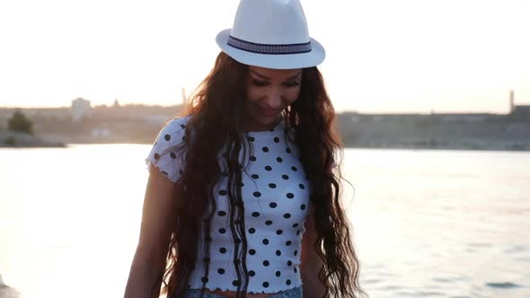 Portrait of a European Beautiful Pretty Brunette in a White Hat a Young Woman or a Cheerful Girl alt