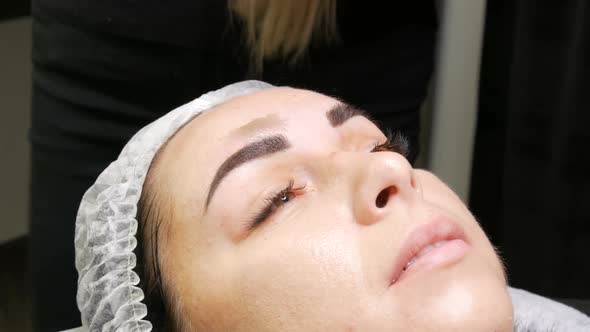 Correction of a Beautiful Aesthetic Shape of Eyebrows with Hot Wax and Special Tweezers