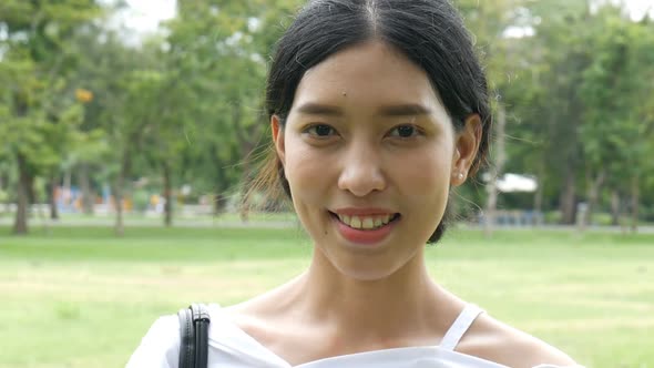 Beautiful young Asian woman Looking at the Camera.