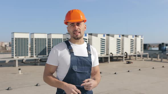 The Happy Engineer is Looking at the Camera and Talking Emotionally alt