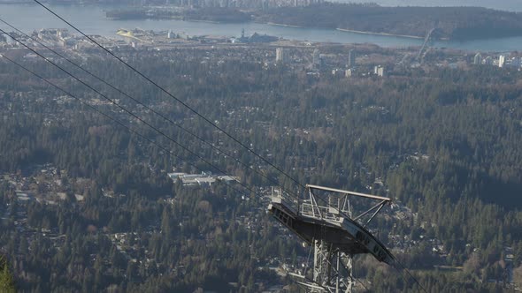 Grouse Mountain Gondola Tower with City in Background alt