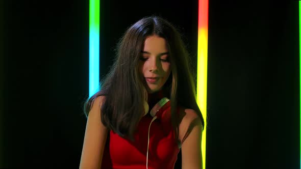Portrait of a Young Pretty Girl in Big Red Headphones Dances and Enjoys the Music. Close Up. Slow alt