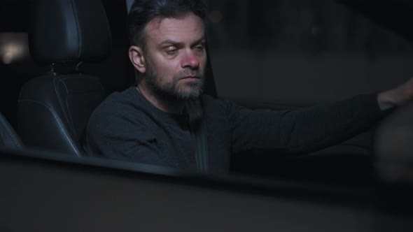 Man Sits in a Car Upset That He Was Stopped By the Police for a Traffic Violation alt