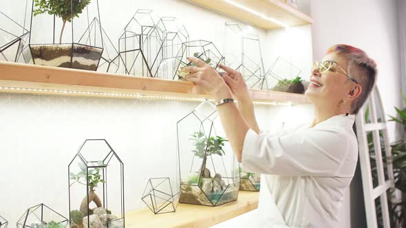 Senior Modern Florist Woman Look After Plants in Capsule alt