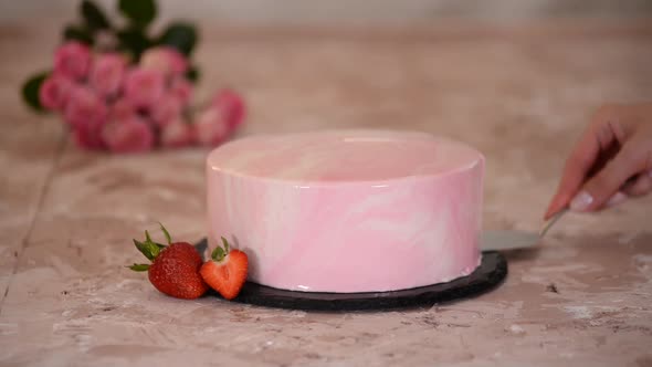 Modern strawberry mousse cake with pink mirror glaze.