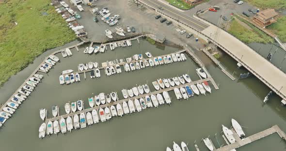 Many Boats and Yachts are Near Pier in Ocean Bay in Sunny Summer Day alt
