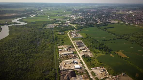 Beautiful drone shot of a vast landscape of forests and industrial facilities. alt
