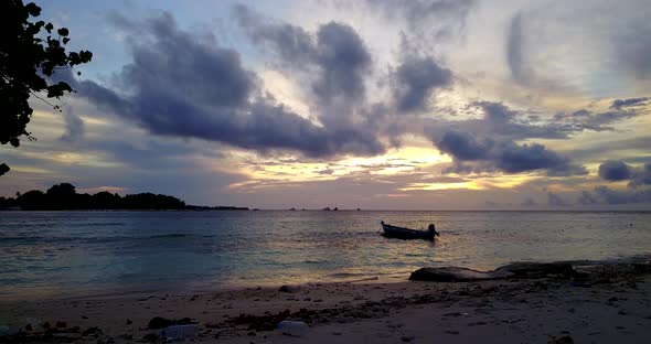 Tropical birds eye clean view of a white paradise beach and blue water background in vibrant 4K alt
