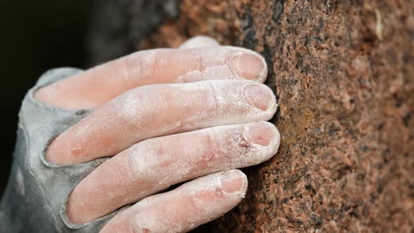 Super Close  Up of a Climber's Fingers Grabbing a Crimper
