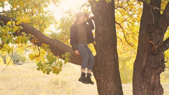 Girl Tourist on a Hike in the Autumn Forest