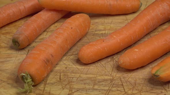 Fresh carrot (daucus carota) on a wooden cutting board