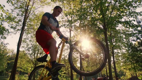 Biker Stunt Performer Effectively Performs Stunts on a Bicycle alt