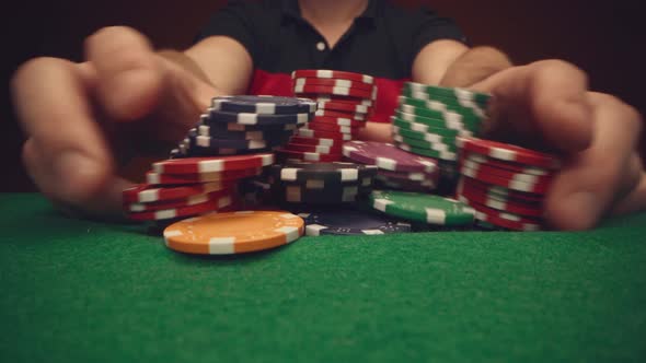 Male Player Moving Casino Chips on Poker Table Close Up