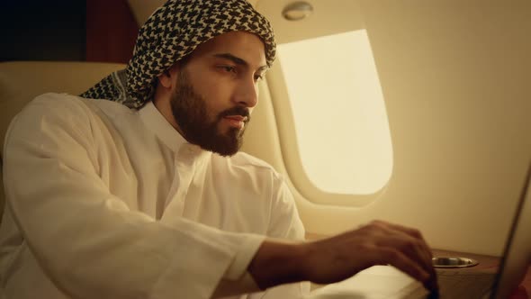 Smiling Businessman Typing Laptop on Jet Closeup alt