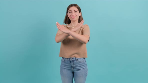 Young Woman Making Stop Gesture Crossing Her Hands alt