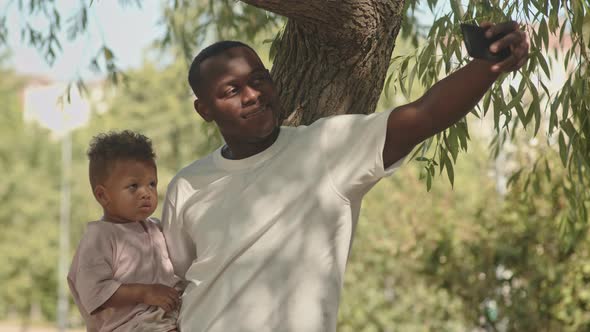 Father Taking Selfie Portrait with Toddler Son alt