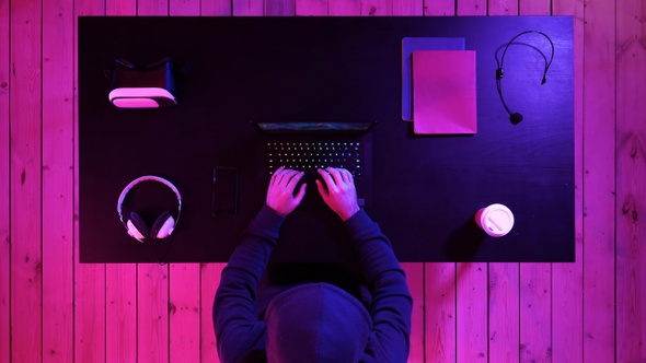 Gamer playing a game on a laptop. Streaming and watching alt