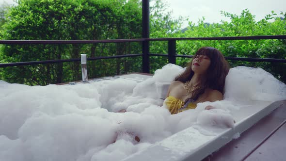 Cute Smiling Asian Girl in Bikini Relaxing in Hot Tube Thailand