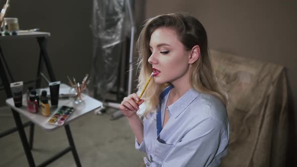 Sexy Blonde Girl Artist in Art Studio