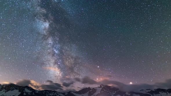 Time Lapse: the Milky way galaxy and stars rotation over the majestic Italian French Alps. Night sky alt
