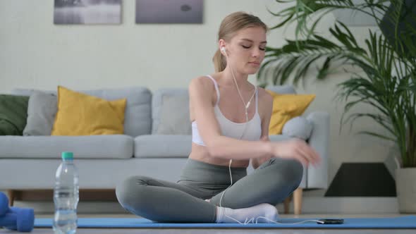 Young Woman Listening Music on Headphones and Meditating alt