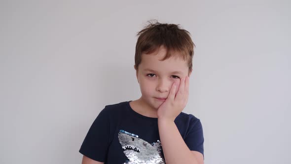 Little Boy Holding His Cheek Toothache alt