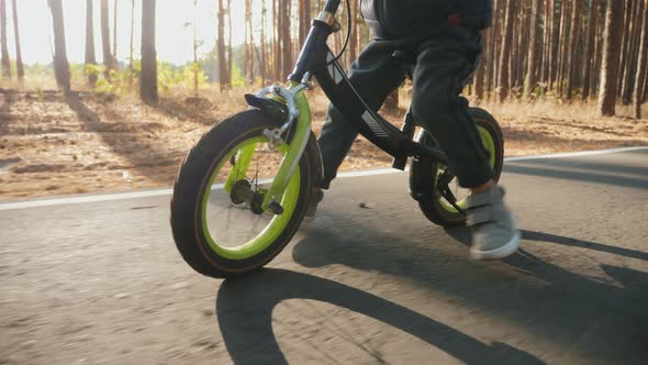A Little Boy Rides on the Balance Bike, Close Up alt