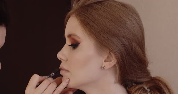 Beautiful girl has her makeup done in a beauty salon.