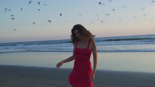 Grateful girl on Santa Monica beach, at sunset alt
