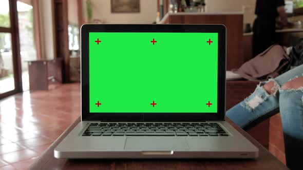 Green screen laptop computer set up for work on wooden desk, Chroma key, Alpha channel.