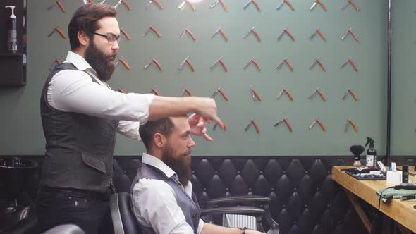 Skillful Barber. Young Man Getting an Old-fashioned Shave with Straight Razor alt