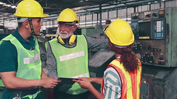 Group of Factory Workers Using Machine Equipment in Factory Workshop alt