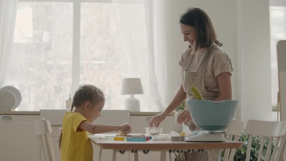 Mom with Little Daughter in the Kitchen