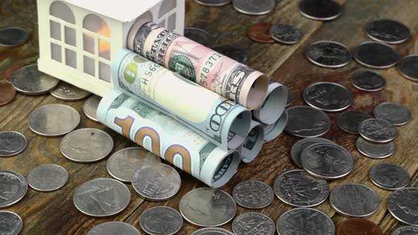 House Near of American Dollars Banknotes Rolled Into Tube and Many Us Coins alt