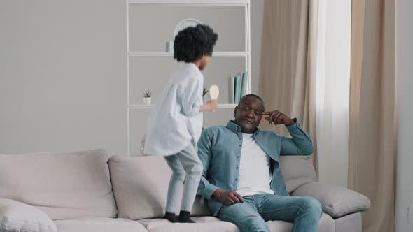 Mature African American Exhausted Tired After Work Father Sitting on Sofa Little Cheerful Noisy alt