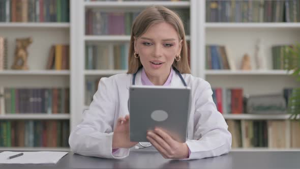 Lady Doctor Celebrating on Tablet in Clinic alt