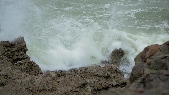 Big stormy waves breaking against abandoned seaside fortification building ruins at Karosta Northern alt