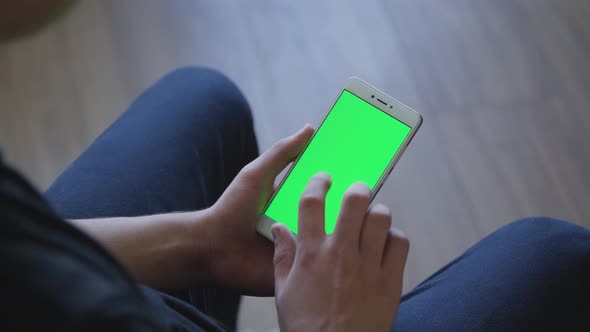 Closeup of Male Hands Holding Smart Phone with Green Screen Prekeyed for Effects. Useful Mobile alt
